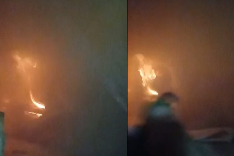 Policial militar resgatando criança de casa em chamas em Nioaque, MS.