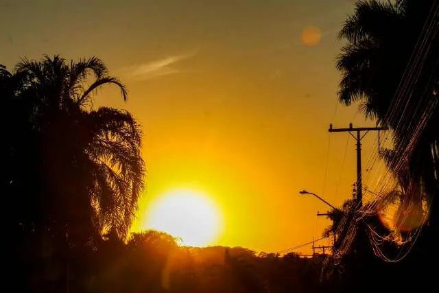 Termômetro marcando 42°C em paisagem seca do Mato Grosso do Sul
