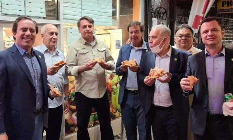 Por não se vacinar, Bolsonaro come pizza em pé e na rua nos EUA